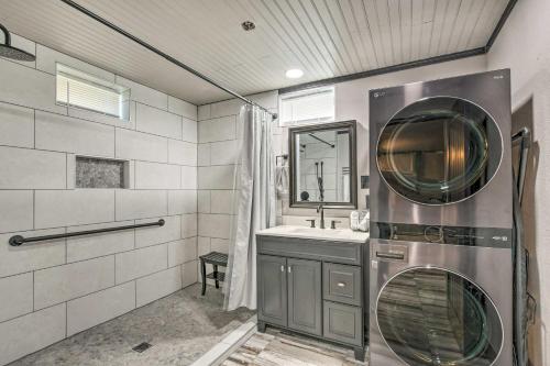a bathroom with a sink and a washing machine at Modern Central Apartment with BBQ Patio and Yard! in Central