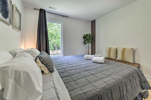 a bedroom with a large bed and a window at Contemporary Raleigh Home about 2 Mi to Downtown! in Raleigh