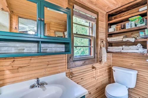 a bathroom with a white sink and a toilet at Rustic Cabin with Patio and Pond on Blue Ridge Parkway in Glade Valley