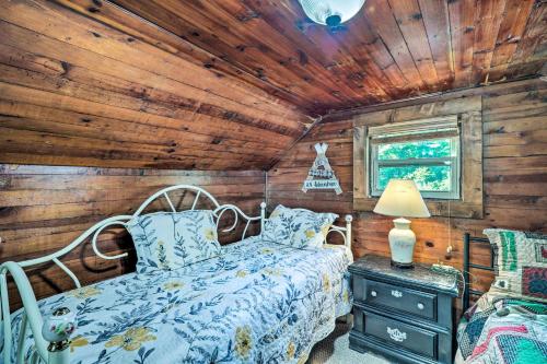 a bedroom with a bed in a log cabin at Cozy Ennice Cabin on the Blue Ridge Parkway! in Glade Valley