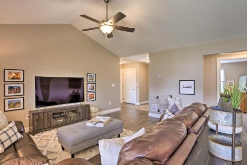 a living room with a couch and a flat screen tv at Rapid City Home with Patio Less Than 5 Mi to Downtown! in Rapid City