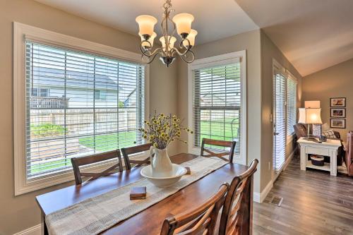 a dining room with a table and chairs and windows at Rapid City Home with Patio Less Than 5 Mi to Downtown! in Rapid City