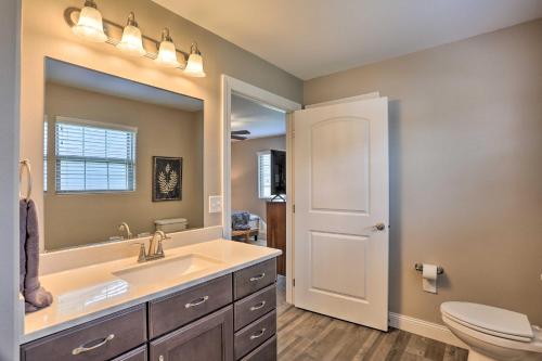 a bathroom with a sink and a toilet and a mirror at Rapid City Home with Patio Less Than 5 Mi to Downtown! in Rapid City