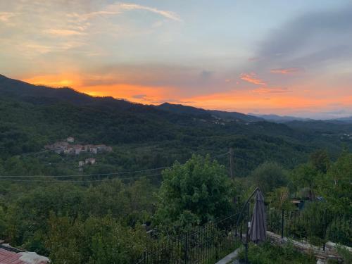 a sunset over a valley with trees and mountains at Rifugio S.Caterina alle 5 Terre in Riccò del Golfo di Spezia