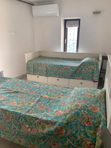 a bedroom with two beds and a mirror at Rifugio S.Caterina alle 5 Terre in Riccò del Golfo di Spezia