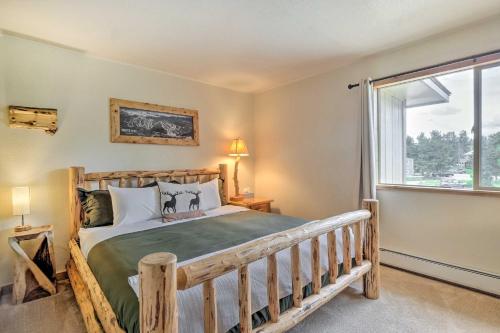 1 dormitorio con cama de madera y ventana en Dog-Friendly Fraser Condo with View and Amenities, en Fraser