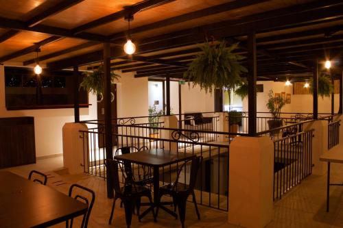 a restaurant with tables and chairs in a room at Hotel Real Alma in Oaxaca City