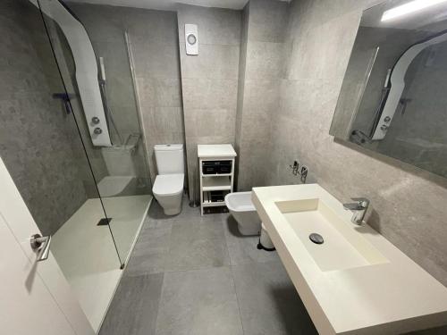 a bathroom with a sink and a toilet and a shower at Valencia Old Town EL CARMEN. in Valencia