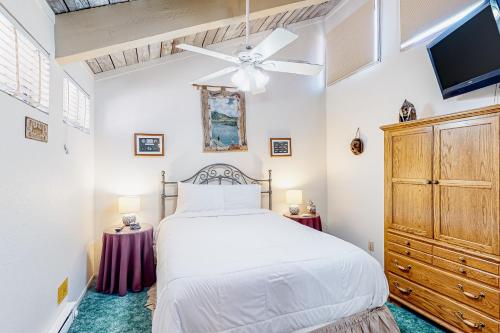 a bedroom with a white bed and a ceiling fan at Mammoth Ski & Racquet 30 in Mammoth Lakes