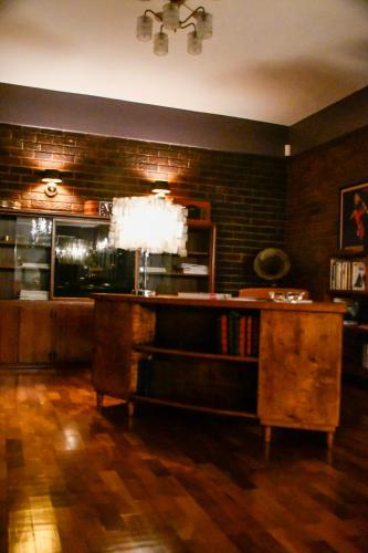a living room with a table and a brick wall at THE WHITE HOUSE in Johannesburg