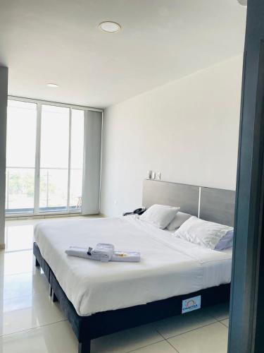 a bedroom with a large bed in a room at Hotel Doral Inn in Ibagué