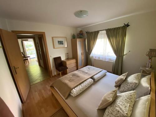 a bedroom with a large bed with pillows on it at Villa СARPE DIEM in Laško