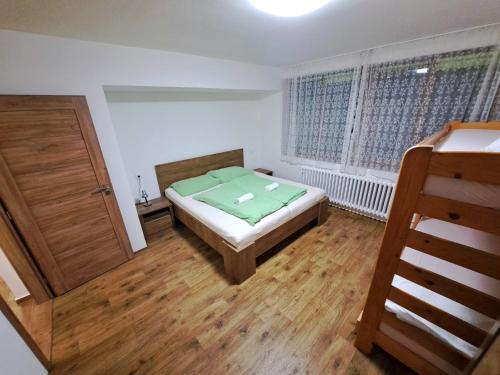 a small bedroom with a bed and a window at Horský Dům Horalka in Železná Ruda