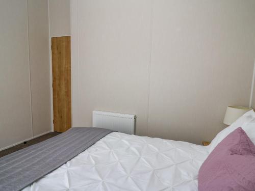 a bedroom with a large bed in a room at Ystwyth 36 in Borth