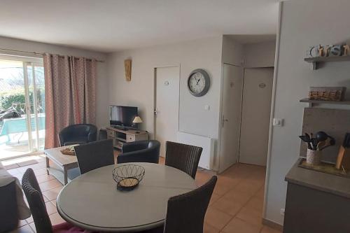 a dining room and living room with a table and chairs at Bastidon Plein Sud in Gordes