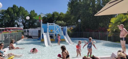 a group of children playing in a swimming pool at Camping la Haie Penée **** in Saint-Quentin-en-Tourmont