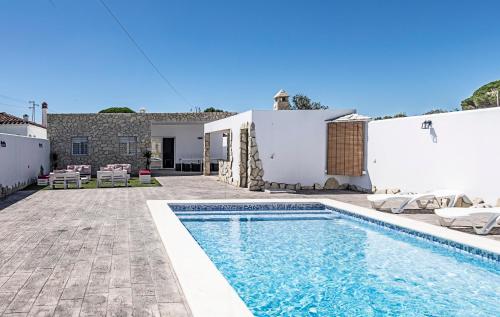 a villa with a swimming pool and a house at Villa mi Pequeña Alba in Barbate