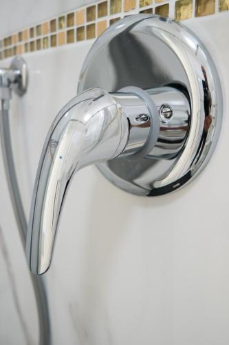 a chrome shower faucet in a bathroom at Guest House Train Station Venice - Atika & Atif in Mestre