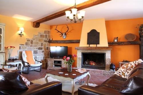 a living room with a couch and a fireplace at La Cantarilla 258 in Aldehuela del Rincón