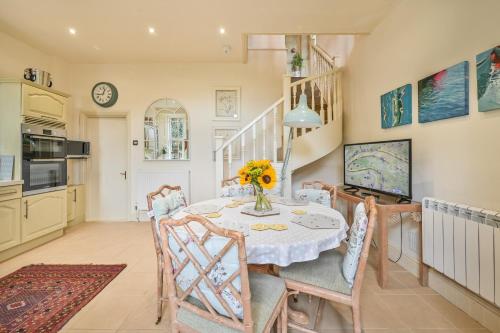 a kitchen and dining room with a table and chairs at The Town House at Muntham- Luxury Holiday Home with Hot Tub in Torquay