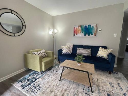 a living room with a blue couch and a table at * Prime Place * Pet Friendly * King Bed * in Durham