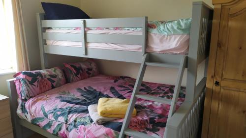 a bunk bed in a room with a bunk bed in a bedroom at Lovely cosy cottage close to Atlantic beaches in Dromore West