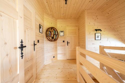 a wooden hallway in a log home with a wooden staircase at Willa Tritri 1 Butikowy dom wakacyjny in Witów