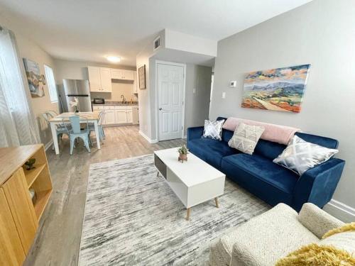 a living room with a blue couch and a table at * Cozy Crib * Pet Friendly * King Bed * in Durham