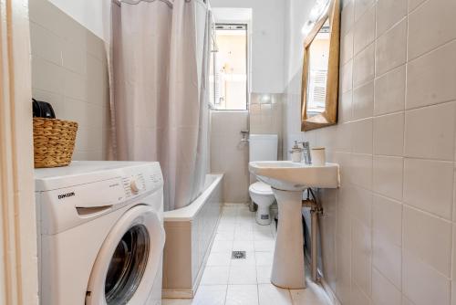 a bathroom with a washing machine and a sink at JoMi House of Art, Old Corfu Town in Corfu Town
