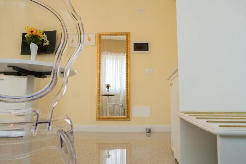 a dressing room with a mirror and a chair at Guest House Train Station Venice - Atika & Atif in Mestre