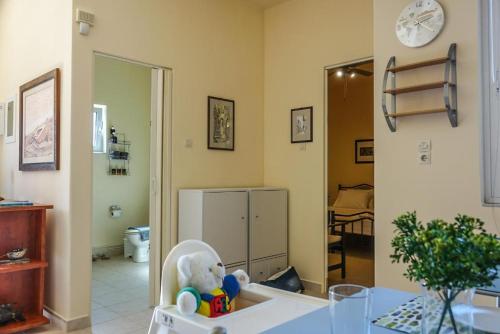 a teddy bear sitting in a high chair in a room at Elafonisi Vacation Blue Apartment in Agios Padeleimon