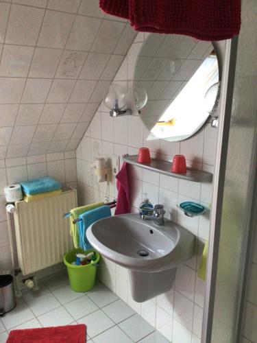 a small bathroom with a sink and a mirror at Nordseekrabbe Bollmann in Carolinensiel