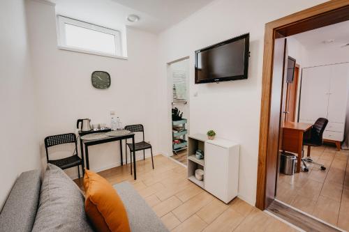 a living room with a couch and a table at City Penzion in Košice