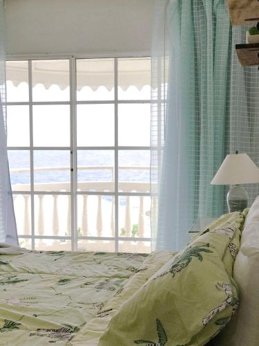 a bedroom with a bed with a view of the ocean at Piergiorgio Palace Hotel in Sosúa