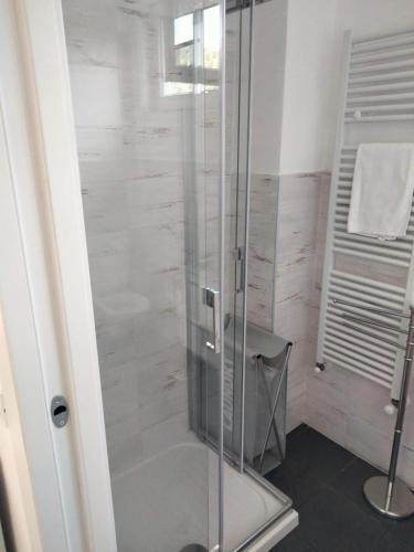 a shower with a glass door in a bathroom at La casa di Nathan vicino baia blu in Lerici