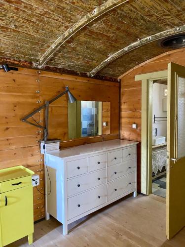 a bathroom with a white dresser with a mirror at HaKaron in Ein HaBesor