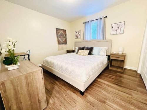 a bedroom with a large bed and a wooden floor at *Prime Pad * King Bed * Long Term Stays* in Durham