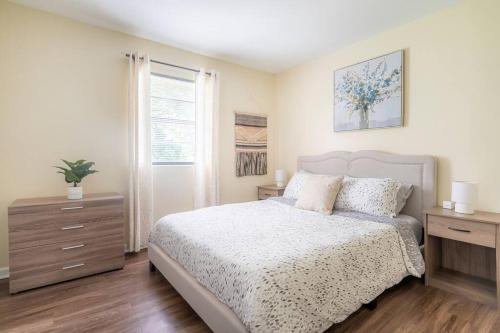 a bedroom with a bed and a dresser and a window at *Cool Crib * King Bed * Long Term Stays * Duke* in Durham