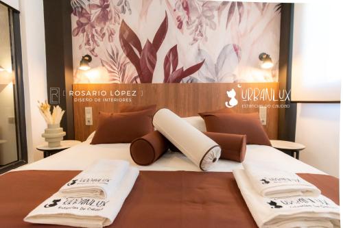 a bedroom with a bed with towels on it at Urbanlux Olimpia Superior in Albacete