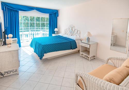 a bedroom with a bed and a large window at Piergiorgio Palace Hotel in Sosúa