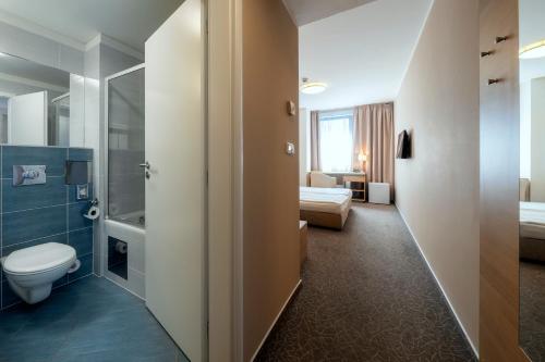 a bathroom with a toilet and a shower at Hotel Ehrlich Prague in Prague
