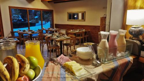 a restaurant with a table with food on it at Encanto del Rio in Villa La Angostura