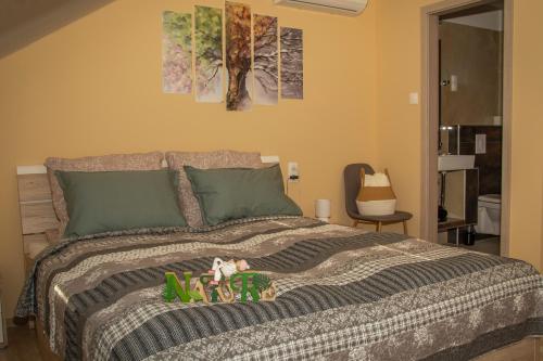 a bedroom with a bed with some toys on it at Oros House Apartmanház in Orosháza