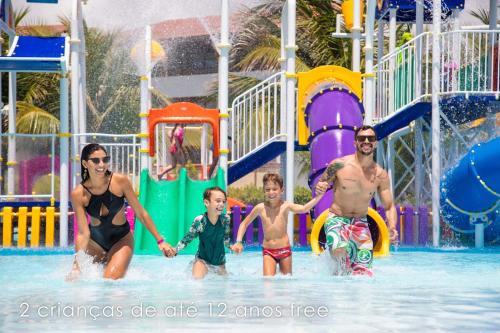 a number of people playing in a pool at Enotel Porto de Galinhas in Porto De Galinhas