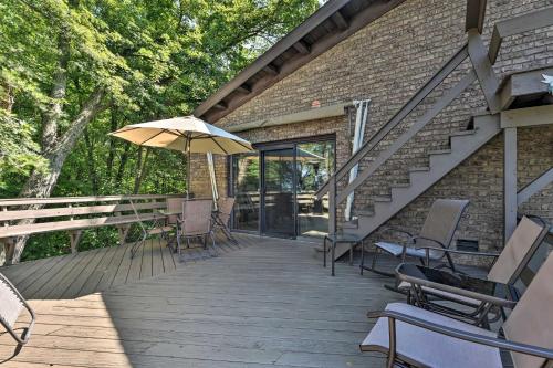 a wooden deck with chairs and an umbrella at Brocton Escape Skiing, Snowtubing, Hiking! in Brocton