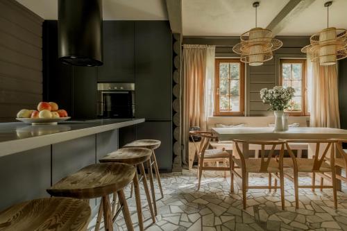a kitchen with a table and chairs and a dining room at Poderey Villas in Yaremche