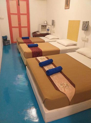 a room with several beds in a room with water at D Riverside Inn in Malacca