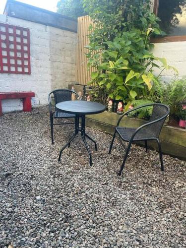 two chairs and a table and a table and chairs at Elmwood House Luxury Seaview Accommodation in Donegal