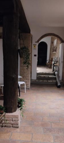 a patio with a table and benches in a building at DIMORA AL SARACENO in Ferrara