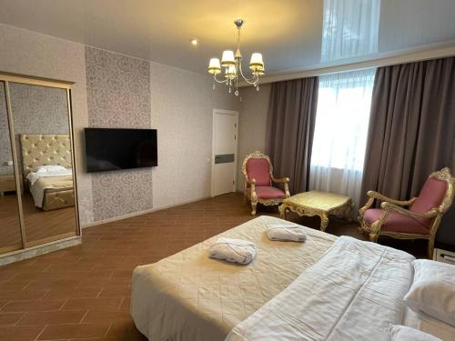 a hotel room with two beds and a television at Viktoriya Family 2 Country complex in Kyiv
